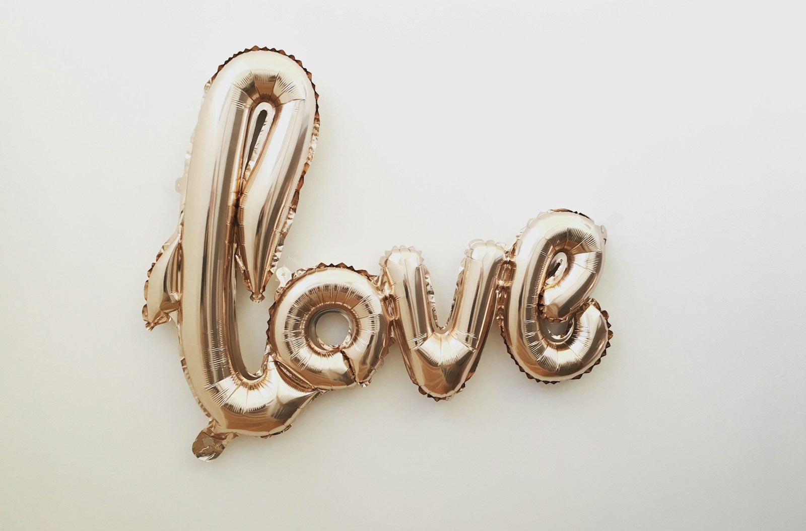 goldener Schriftzug "love" als Luftballon